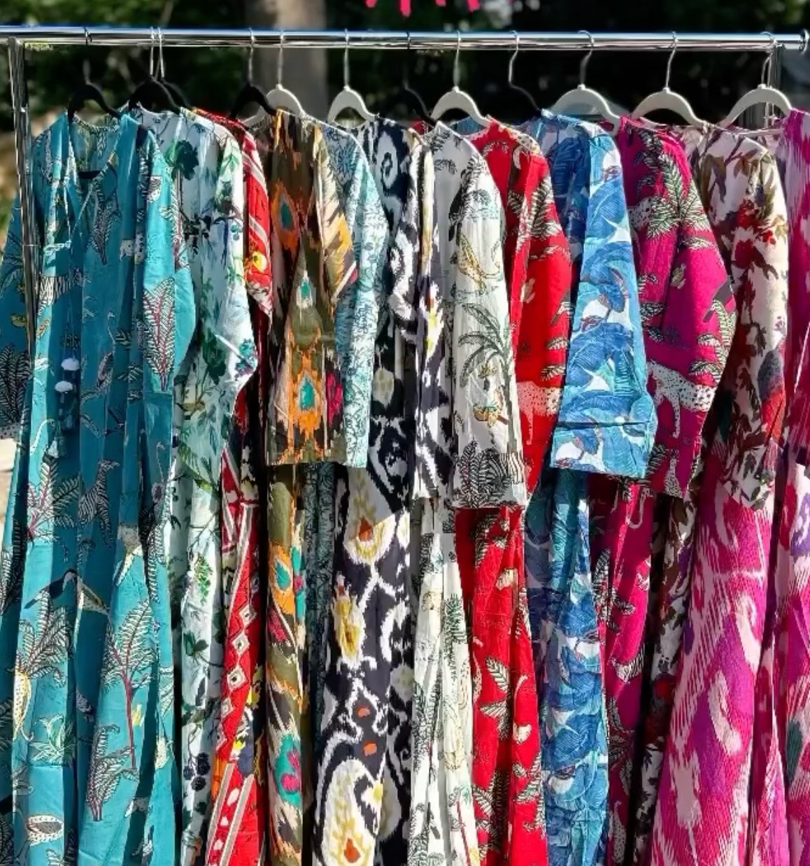 Colorful printed dresses on rack at Hunt + Trade